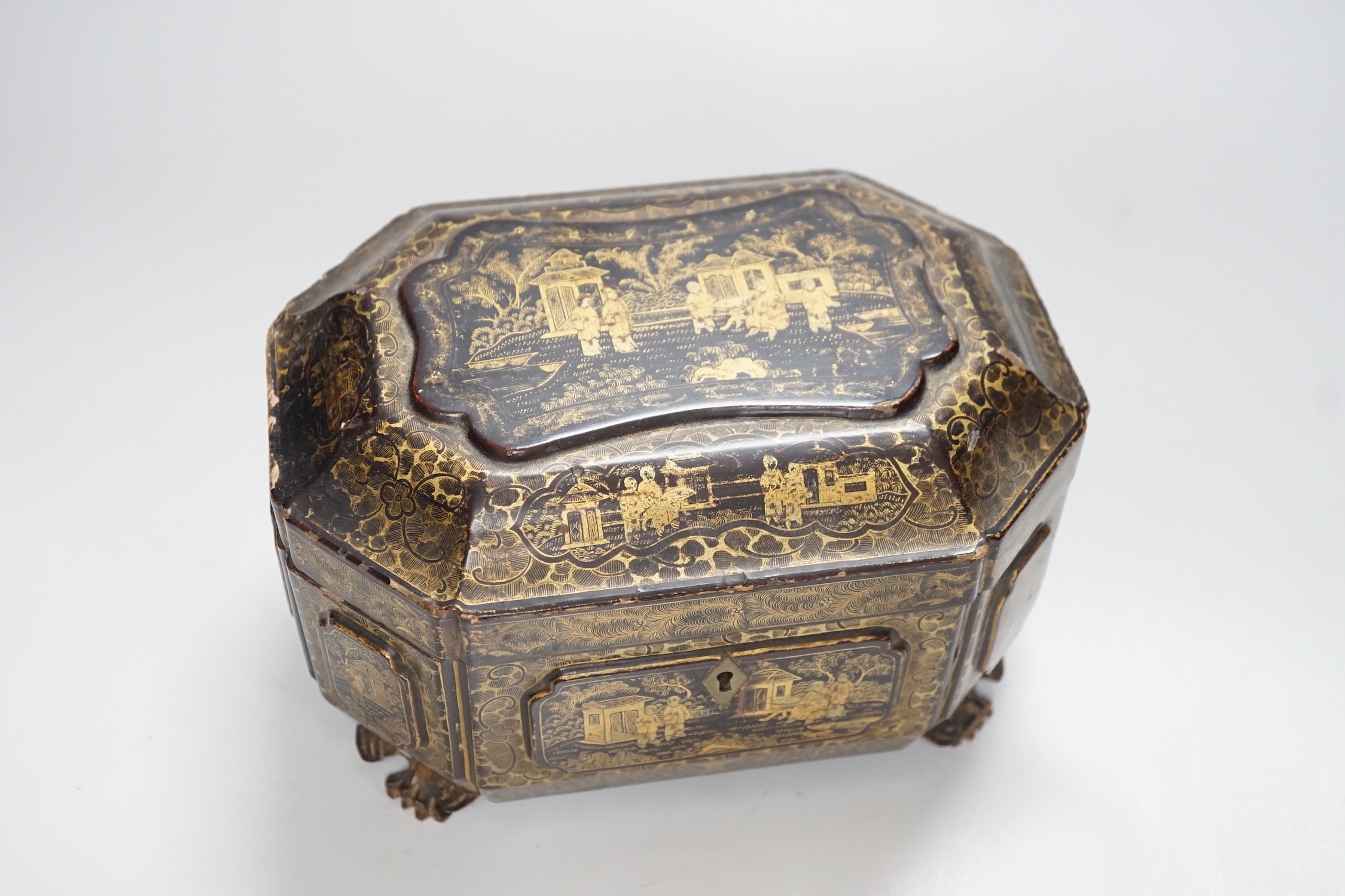 A 19th century Chinese chinoiserie lacquered sarcophagus form tea caddy, pewter lined interior with bone handles, 23cm